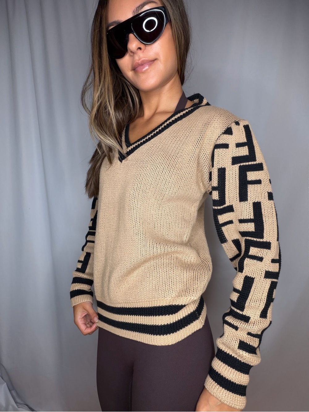 Beige V-Neck Sweater with Black Patterned Sleeves